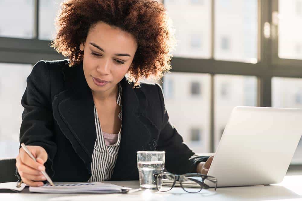 Aikens Group team member reviewing benefits paperwork at a desk